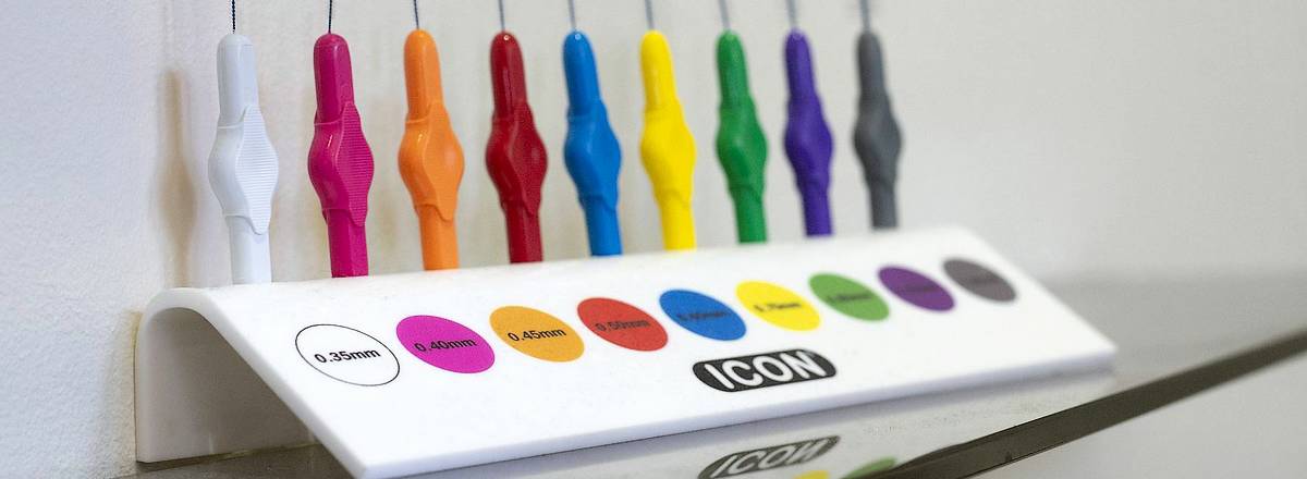 Coloured dental picks in stand